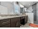 Elegant bathroom featuring a double vanity with granite countertops and a glass-enclosed shower at 18826 Reynolds Pkwy, Orlando, FL 32833