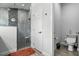 Modern bathroom featuring a glass-enclosed shower with gray tile, and a separate toilet area at 18826 Reynolds Pkwy, Orlando, FL 32833