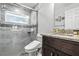 Modern bathroom with a vessel sink, granite countertops, and a beautifully tiled walk-in shower at 18826 Reynolds Pkwy, Orlando, FL 32833