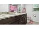 Stylish bathroom with a double vanity, granite countertops, and Hello Kitty themed décor at 18826 Reynolds Pkwy, Orlando, FL 32833