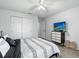 Inviting bedroom featuring gray walls, white closet and a TV; decorated with modern themed bedding at 18826 Reynolds Pkwy, Orlando, FL 32833