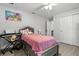 Charming bedroom featuring light gray walls, closet, and a bed with playful pink bedding at 18826 Reynolds Pkwy, Orlando, FL 32833