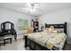 Cozy bedroom showcasing a vanity, large window, and Paris themed bed with a plush headboard at 18826 Reynolds Pkwy, Orlando, FL 32833