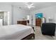 Comfortable bedroom with wood look tile, an ensuite bathroom, and large windows, ensuring a peaceful night's sleep at 18826 Reynolds Pkwy, Orlando, FL 32833