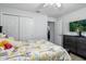 Bright bedroom with neutral walls, closet and dresser; decorated with a yellow Paris themed comforter at 18826 Reynolds Pkwy, Orlando, FL 32833