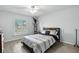 Bright bedroom with a ceiling fan, window, and wood look plank flooring at 18826 Reynolds Pkwy, Orlando, FL 32833