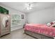 Light-filled bedroom featuring a twin bed, closet, and window with views of lush greenery at 18826 Reynolds Pkwy, Orlando, FL 32833