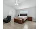 Bright bedroom with a ceiling fan, large window, and wooden furniture, offering a relaxing retreat at 18826 Reynolds Pkwy, Orlando, FL 32833