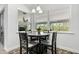 Bright breakfast nook with a round table, four chairs, and large windows overlooking the backyard at 18826 Reynolds Pkwy, Orlando, FL 32833
