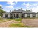 Elegant single-story home showcases a lush front yard, double door entry and well maintained landscape at 18826 Reynolds Pkwy, Orlando, FL 32833