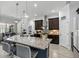 Modern kitchen features a large island with seating, stainless steel appliances, and dark wood cabinetry at 18826 Reynolds Pkwy, Orlando, FL 32833