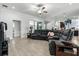 Spacious living room with gray wood-look tile flooring and a comfortable sectional sofa at 18826 Reynolds Pkwy, Orlando, FL 32833