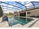 Screened-in swimming pool with stone surround and water feature at 18826 Reynolds Pkwy, Orlando, FL 32833