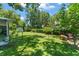 Large, well-manicured backyard with mature trees and a storage shed at 1924 Summerfield Rd, Winter Park, FL 32792