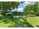 Backyard with Screen Porch and lush landscaping, creating a private retreat at 1924 Summerfield Rd, Winter Park, FL 32792