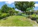 Expansive backyard with mature trees and lush lawn, providing ample space for outdoor activities at 1924 Summerfield Rd, Winter Park, FL 32792