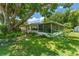 Spacious backyard featuring a screen porch and lush greenery, perfect for outdoor living at 1924 Summerfield Rd, Winter Park, FL 32792