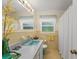 Bathroom with yellow tile, and a bright mirror at 1924 Summerfield Rd, Winter Park, FL 32792