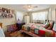 Cozy bedroom featuring a ceiling fan, a bright window and cheerful decor at 1924 Summerfield Rd, Winter Park, FL 32792