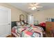 Comfortable bedroom featuring a ceiling fan and a cheerful colorful quilt at 1924 Summerfield Rd, Winter Park, FL 32792