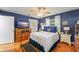 Bedroom with blue walls, wooden floor and exercise equipment at 1924 Summerfield Rd, Winter Park, FL 32792