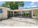 Charming single-story home featuring a light colored brick facade and a covered carport at 1924 Summerfield Rd, Winter Park, FL 32792