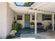 Charming front porch featuring a vibrant yellow floral wreath and cozy seating area at 1924 Summerfield Rd, Winter Park, FL 32792