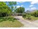 Charming single-story home with a lovely front yard and a curved driveway leading to a carport at 1924 Summerfield Rd, Winter Park, FL 32792