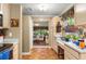 Traditional kitchen featuring wood cabinets and flooring that flows into the living room at 1924 Summerfield Rd, Winter Park, FL 32792