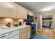 The kitchen area has an open design and modern appliances with a view into the adjacent sun room at 1924 Summerfield Rd, Winter Park, FL 32792