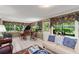 Bright sun room with a piano, comfortable seating, and large windows that provide plenty of light at 1924 Summerfield Rd, Winter Park, FL 32792