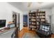 Bright office with bookshelves, wood floors, and a comfortable chair for reading at 1924 Summerfield Rd, Winter Park, FL 32792