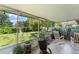 Comfortable screened-in porch overlooking a well-maintained backyard with lush greenery at 1924 Summerfield Rd, Winter Park, FL 32792