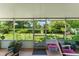 This view from the screen porch looks out to the large well-manicured backyard at 1924 Summerfield Rd, Winter Park, FL 32792