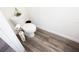 This bathroom showcases modern gray wood-look flooring and crisp white paint at 193 E Warren Ave, Longwood, FL 32750