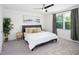 This bedroom offers a calming color palette, ceiling fan, neutral rug, and plenty of natural light at 193 E Warren Ave, Longwood, FL 32750