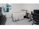 Cozy bedroom with a comfortable bed, accent pillows, natural light, and an adjacent computer desk at 193 E Warren Ave, Longwood, FL 32750