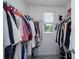 Walk-in closet with ample storage and organization solutions, providing a neat space for clothes and accessories at 193 E Warren Ave, Longwood, FL 32750