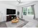 Cozy living room with a comfortable sectional sofa, large TV, and plenty of natural light at 193 E Warren Ave, Longwood, FL 32750