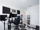 This home office is equipped with dual monitors, sound equipment, and acoustic treatments for an efficient workspace at 193 E Warren Ave, Longwood, FL 32750