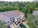 Aerial shot highlighting the home's roofline, three-car garage, and community setting at 1941 Sunset Palm Dr, Apopka, FL 32712
