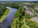 Aerial view of property with access to canal and wooded areas at 1941 Sunset Palm Dr, Apopka, FL 32712