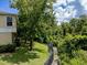 View of fenced backyard space with mature trees and landscaping at 1941 Sunset Palm Dr, Apopka, FL 32712