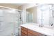 The bathroom features a glass-enclosed shower, a vanity, and a large mirror at 1941 Sunset Palm Dr, Apopka, FL 32712