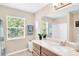 Bright bathroom with window over the sink and combined shower-tub is pristine and appealing at 1941 Sunset Palm Dr, Apopka, FL 32712