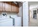 Well-maintained laundry room with washer, dryer, and storage cabinets offers ample space at 1941 Sunset Palm Dr, Apopka, FL 32712