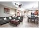 Inviting living room with tile flooring, ceiling fan, and a view of the dining area and front entry at 1941 Sunset Palm Dr, Apopka, FL 32712