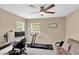 Home office includes a desk, treadmill, and sofa for a convenient place to work and exercise at 1941 Sunset Palm Dr, Apopka, FL 32712