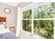 A large window view of lush trees provides plenty of natural light to this gorgeous home at 1941 Sunset Palm Dr, Apopka, FL 32712