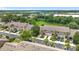 Aerial view of townhomes with lush tropical trees and well-maintained lawns at 2092 Switch Grass Cir, Ocoee, FL 34761